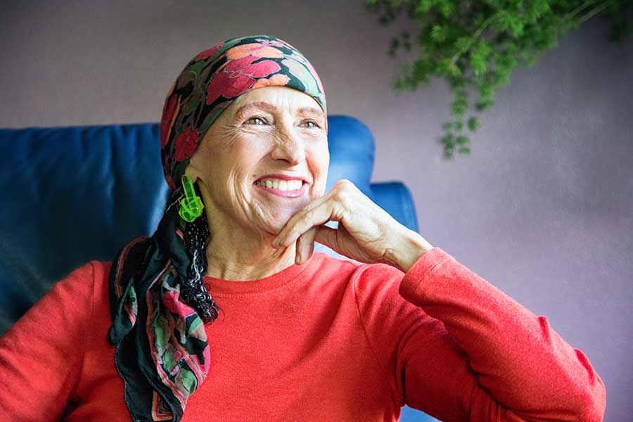 senior woman wearing scarf on head and smiling