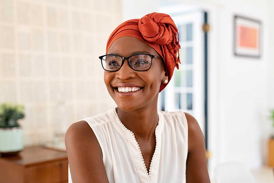 woman wearing scarf on head and smiling