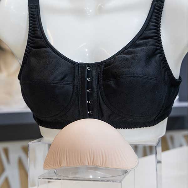 black bra with breast prostheses on display in front
